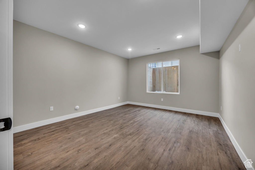 Spare room with recessed lighting, baseboards, and dark wood finished floors