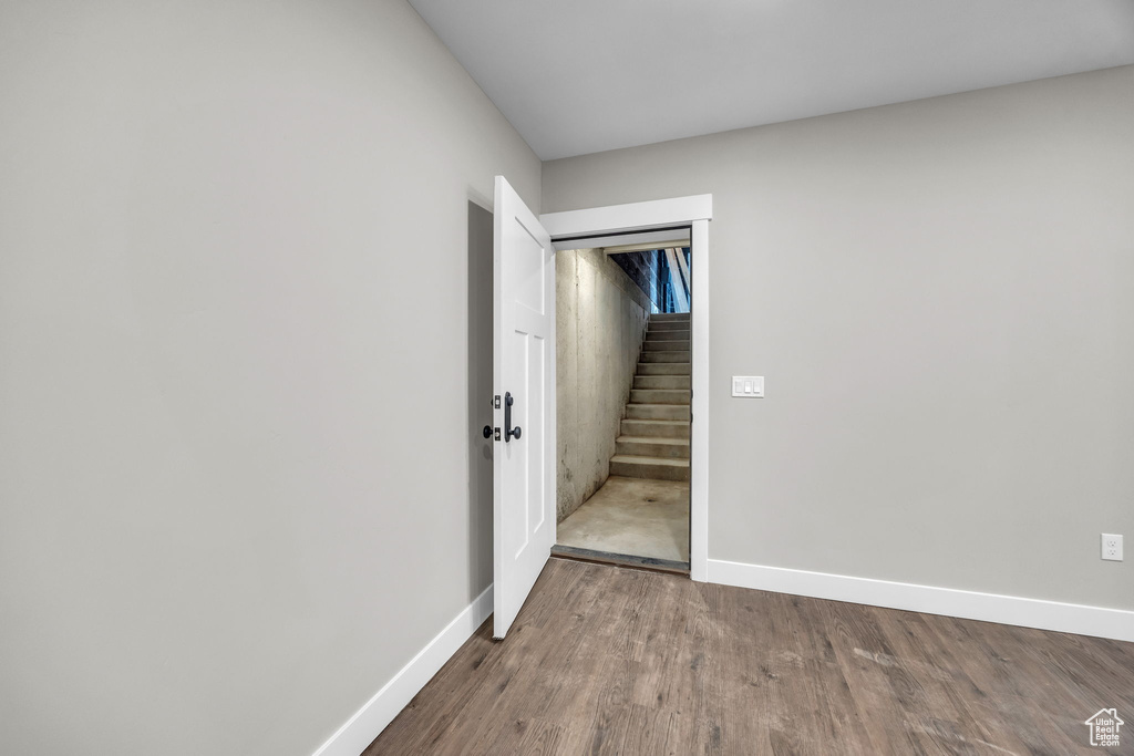 Empty room with baseboards and wood finished floors