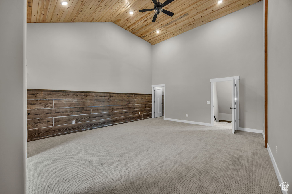 Carpeted spare room featuring recessed lighting, ceiling fan, wood ceiling, and high vaulted ceiling