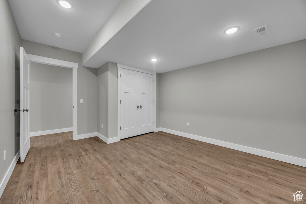 Below grade area with baseboards, recessed lighting, wood finished floors, and visible vents