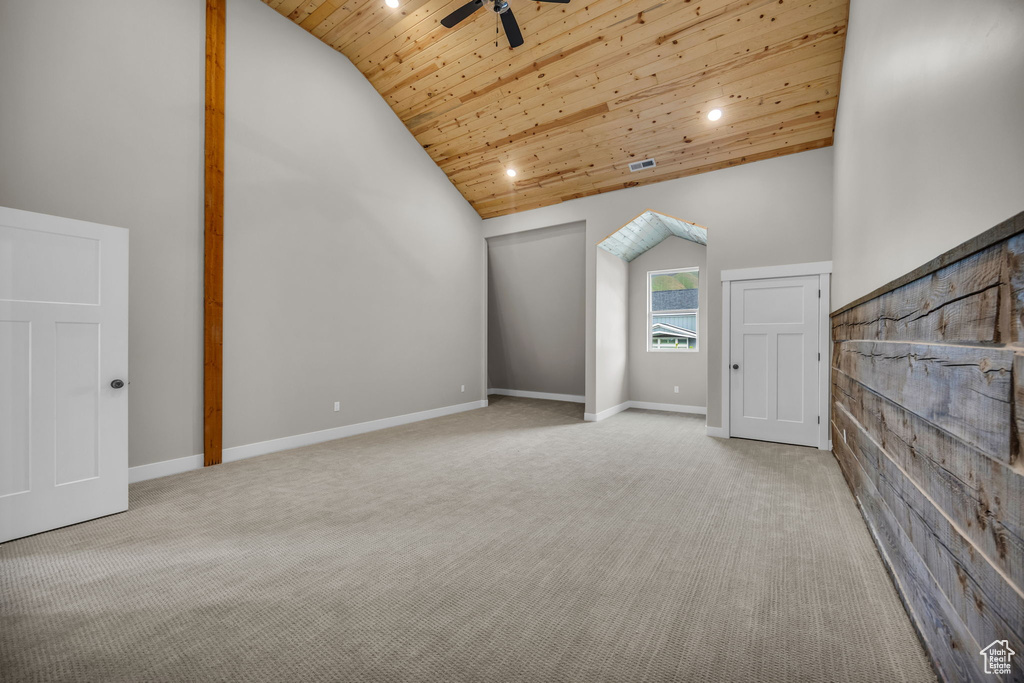 Additional living space with wooden ceiling, a ceiling fan, high vaulted ceiling, and carpet flooring