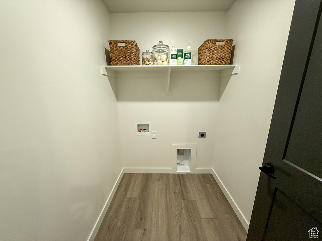 Laundry room with washer hookup, laundry area, baseboards, wood finished floors, and hookup for an electric dryer