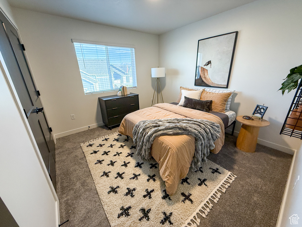 Carpeted bedroom featuring baseboards