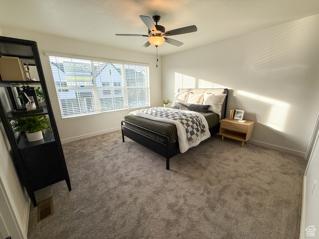 Bedroom featuring baseboards, multiple windows, and visible vents