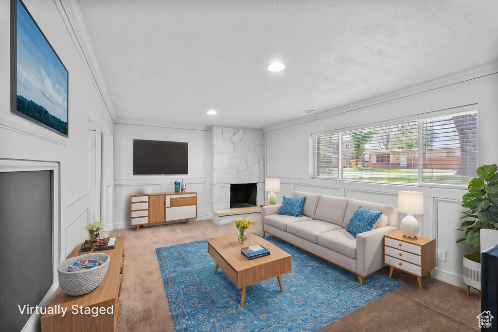 Living area featuring crown molding, carpet floors, and a decorative wall