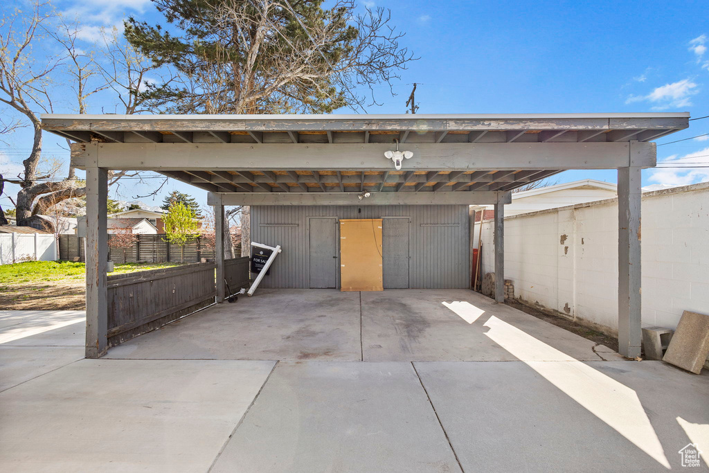 Garage featuring a carport and fence