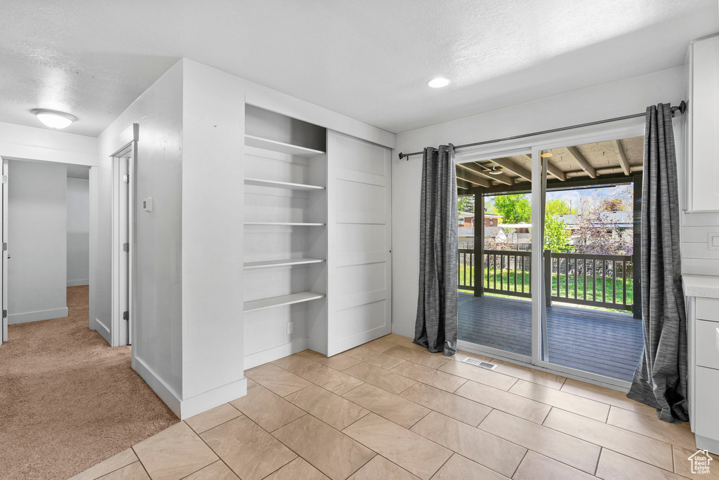 Empty room with visible vents, recessed lighting, a textured ceiling, and light tile patterned flooring