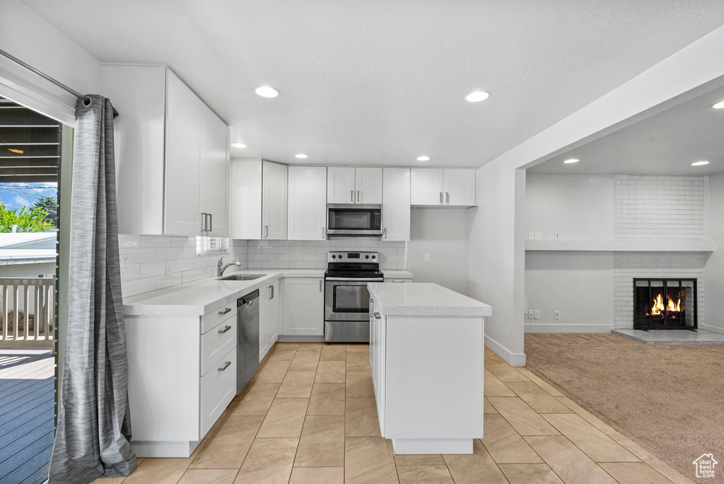 Kitchen featuring recessed lighting, light countertops, appliances with stainless steel finishes, and backsplash