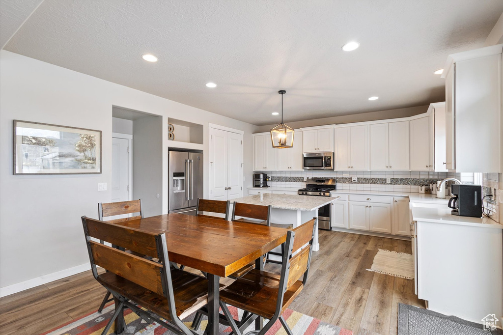 Dining space featuring recessed lighting, baseboards, and light wood-type flooring