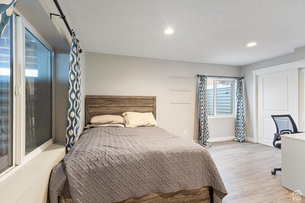 Bedroom with recessed lighting, baseboards, and light wood finished floors