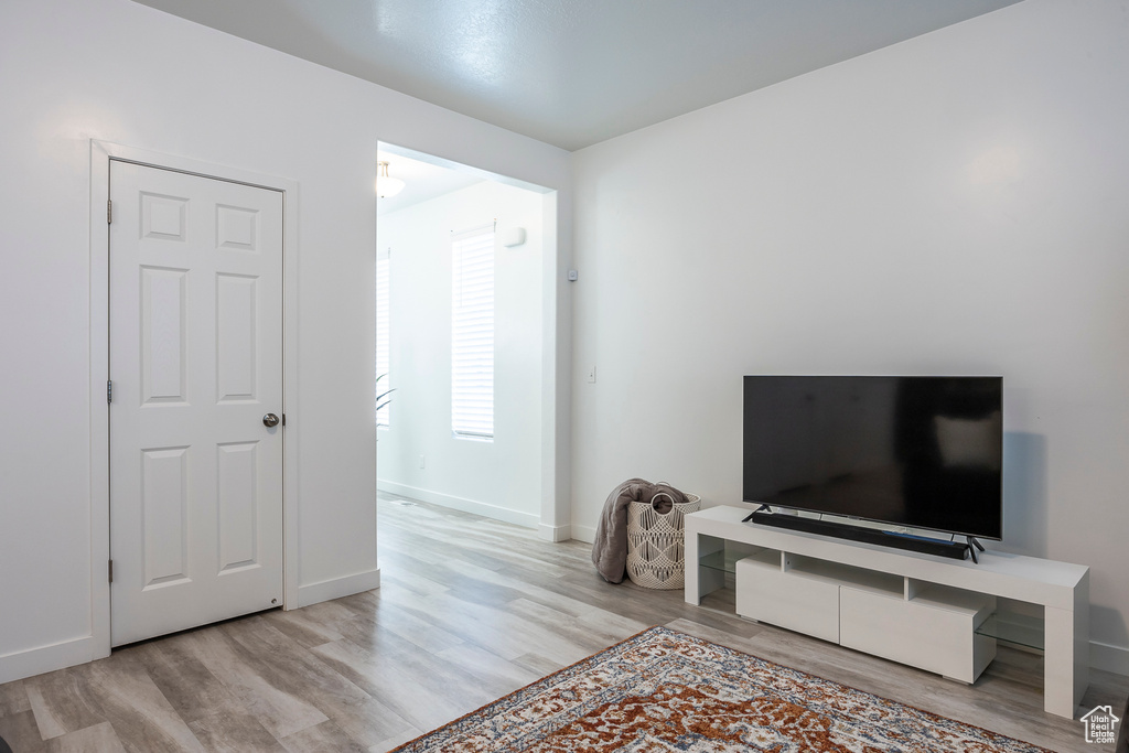 Interior space with baseboards and wood finished floors