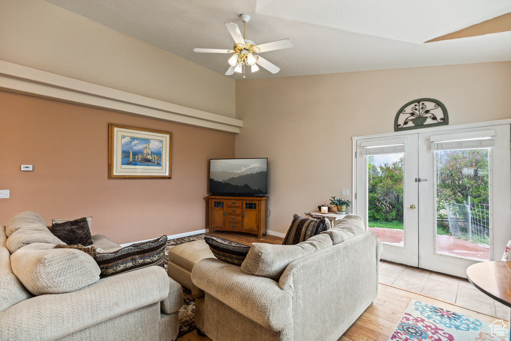 Living area featuring french doors, ceiling fan, light wood-style flooring, and lofted ceiling