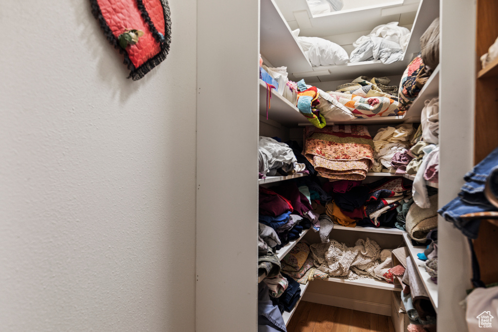 Walk in closet featuring wood finished floors