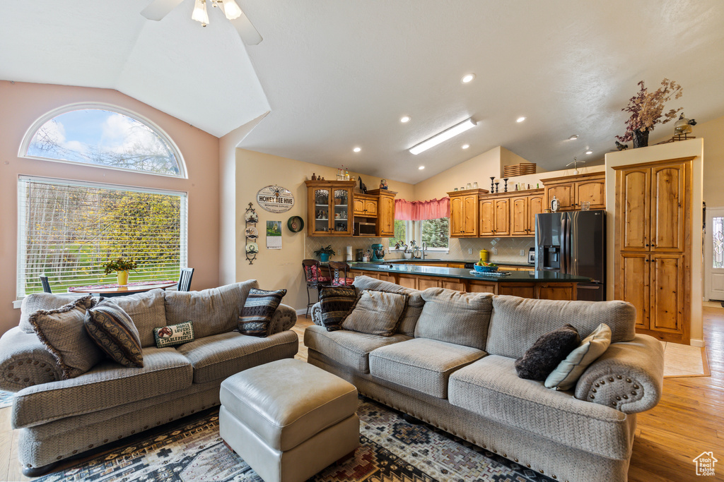Living area featuring recessed lighting, a ceiling fan, light wood finished floors, and lofted ceiling
