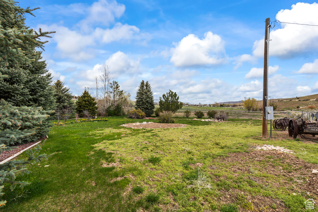 View of yard featuring fence and a rural view