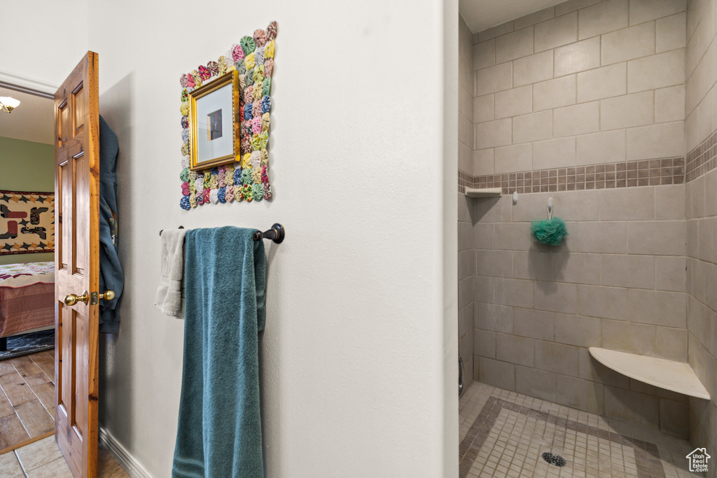 Ensuite bathroom featuring tile patterned flooring, a tile shower, and ensuite bath