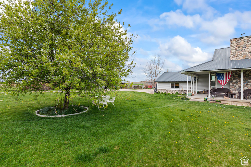 View of yard featuring covered porch