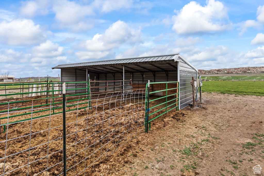 View of outdoor structure with an exterior structure, a rural view, and an outbuilding