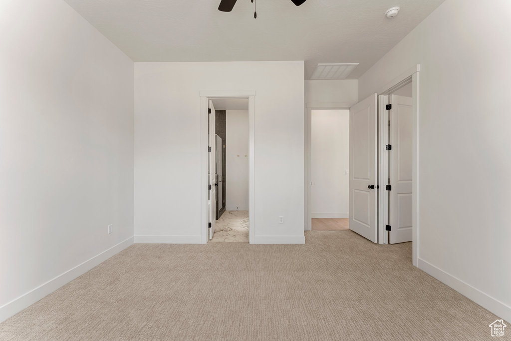 Unfurnished bedroom with baseboards, light carpet, and a ceiling fan