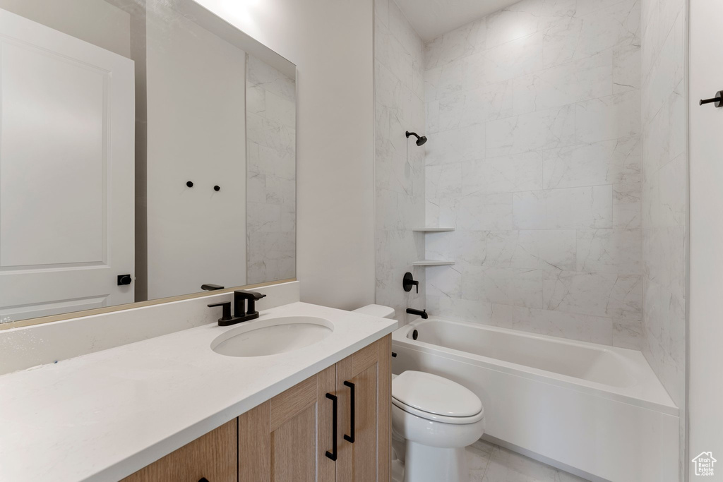 Full bath with vanity,  shower combination, and toilet