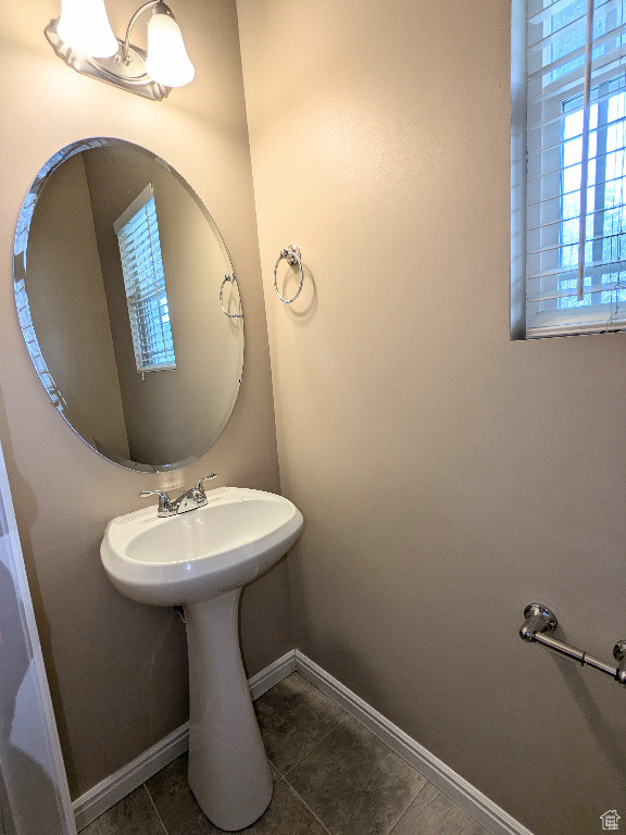 Bathroom featuring tile patterned floors and baseboards