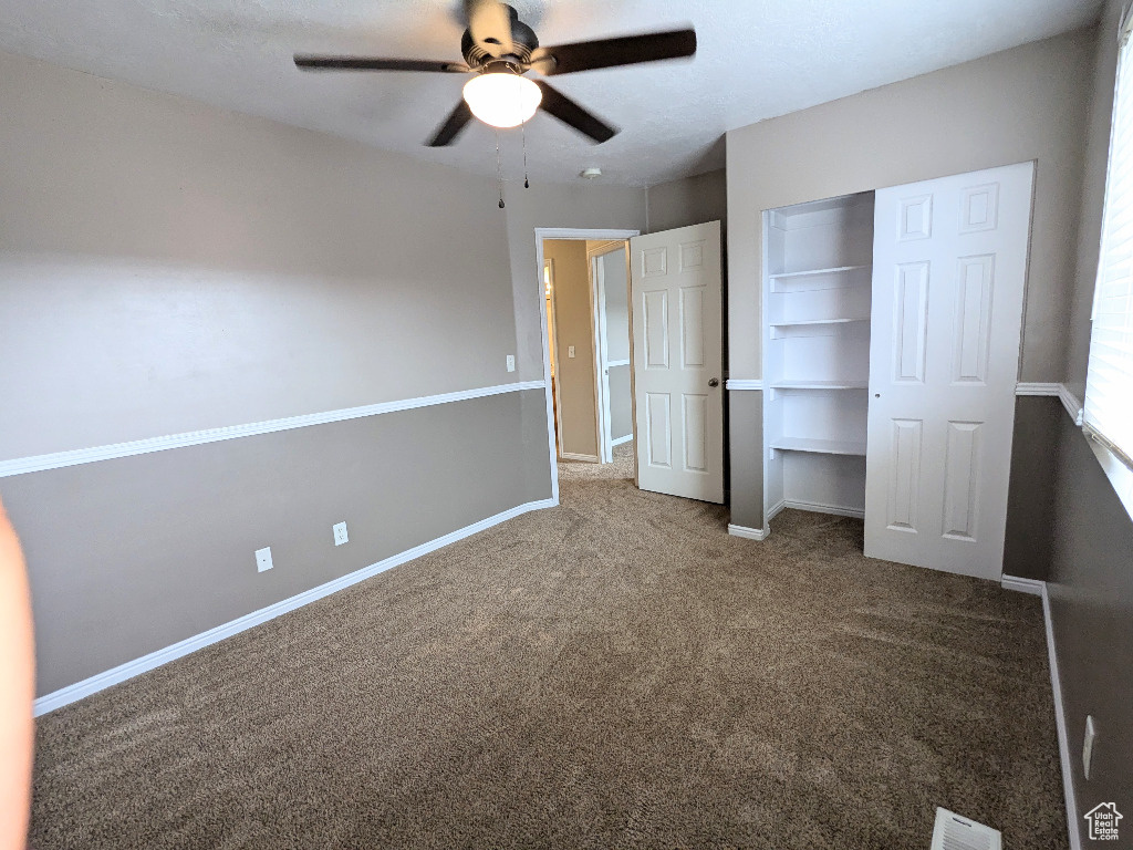 Unfurnished bedroom featuring baseboards, carpet flooring, and visible vents