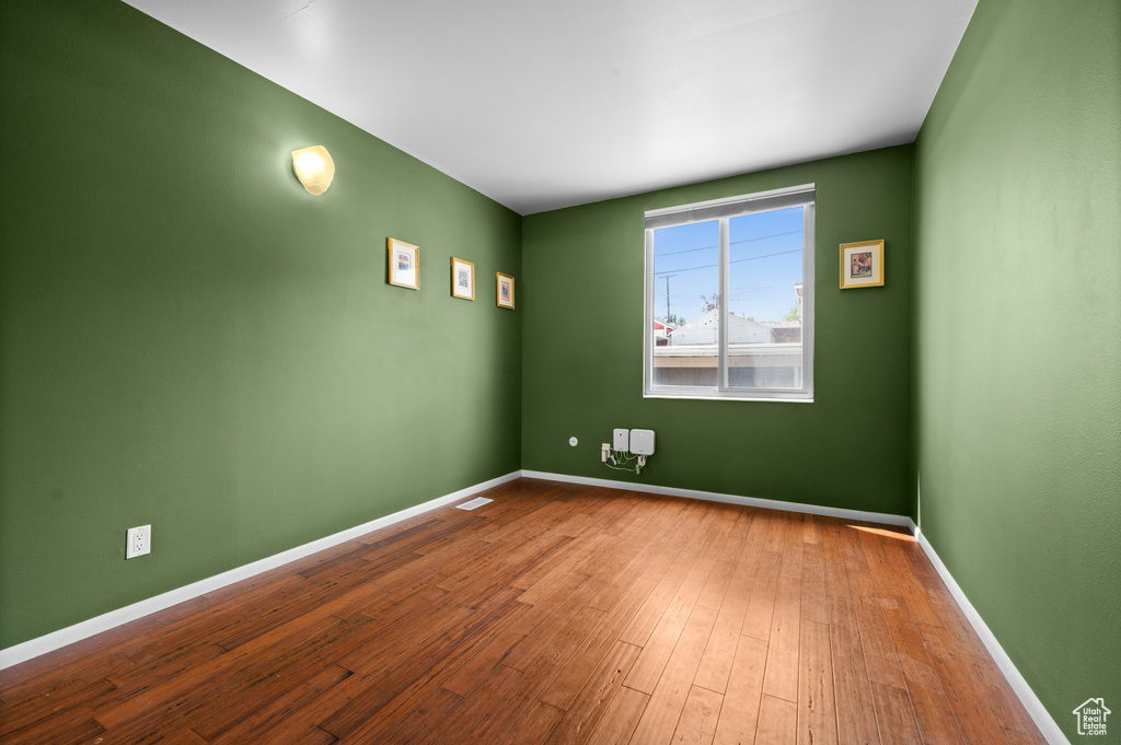 Unfurnished room featuring baseboards and wood finished floors