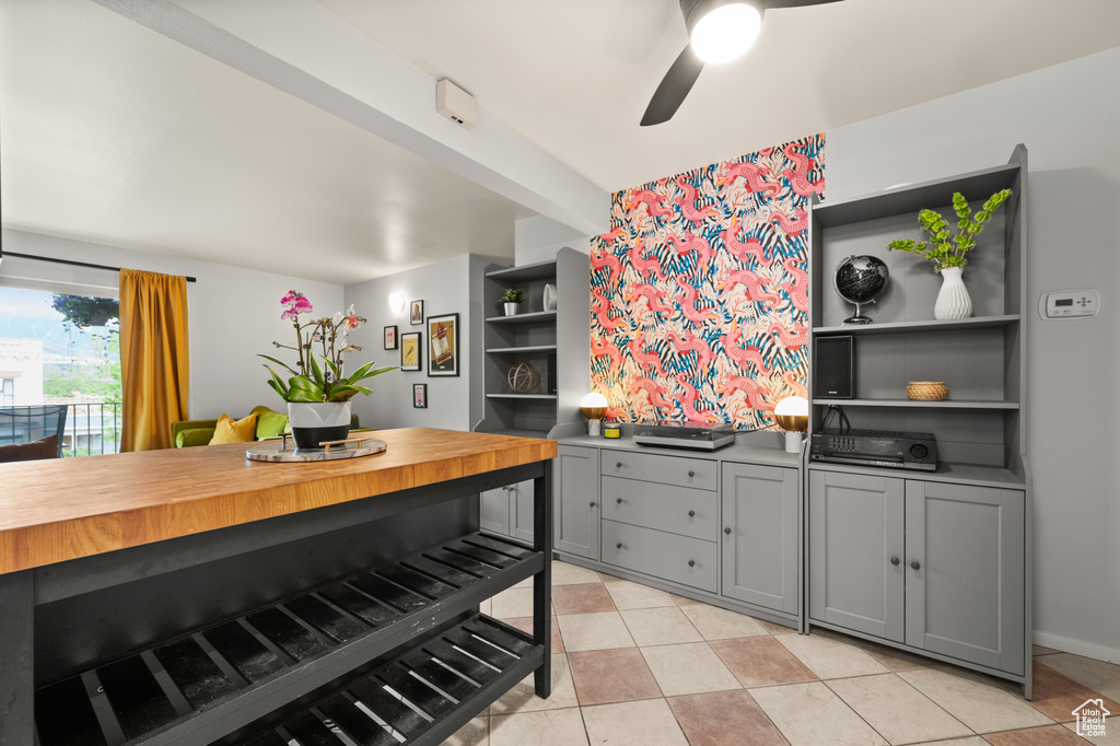 Kitchen with open shelves, ceiling fan, light tile patterned flooring, and gray cabinetry