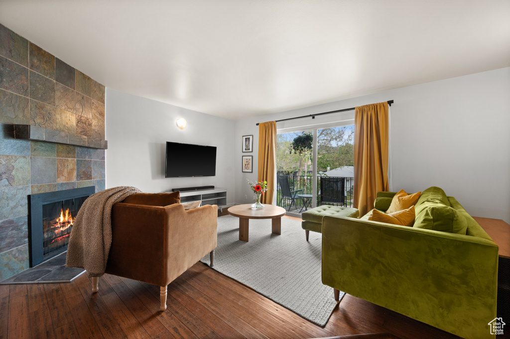 Living room featuring hardwood / wood-style floors and a tile fireplace