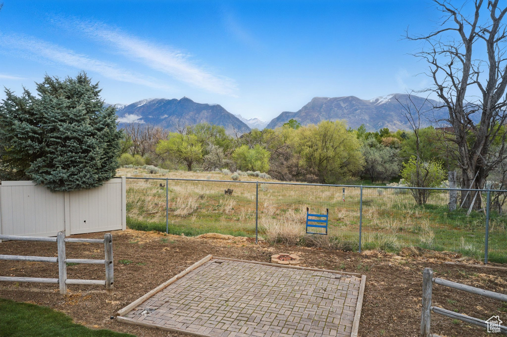 View of yard with fence and a mountain view