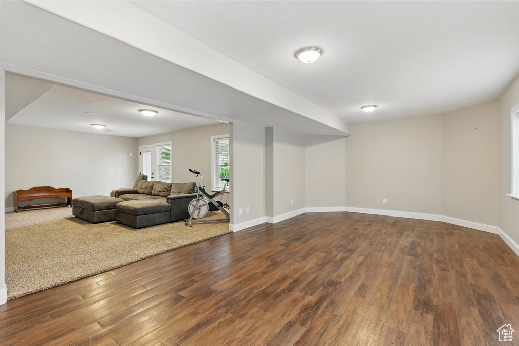 Living room with dark wood-style flooring and baseboards
