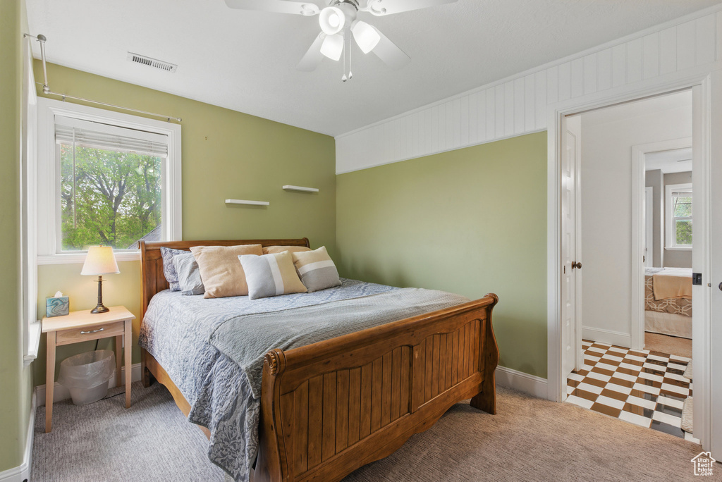 Bedroom with baseboards, visible vents, ceiling fan, and tile patterned floors
