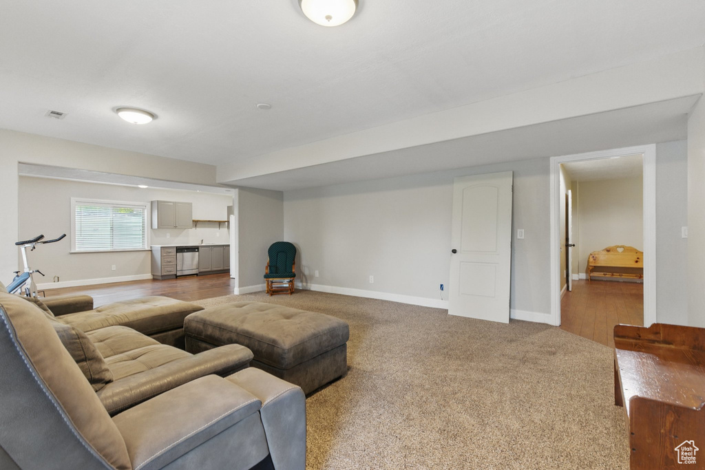 Living area with baseboards and carpet flooring