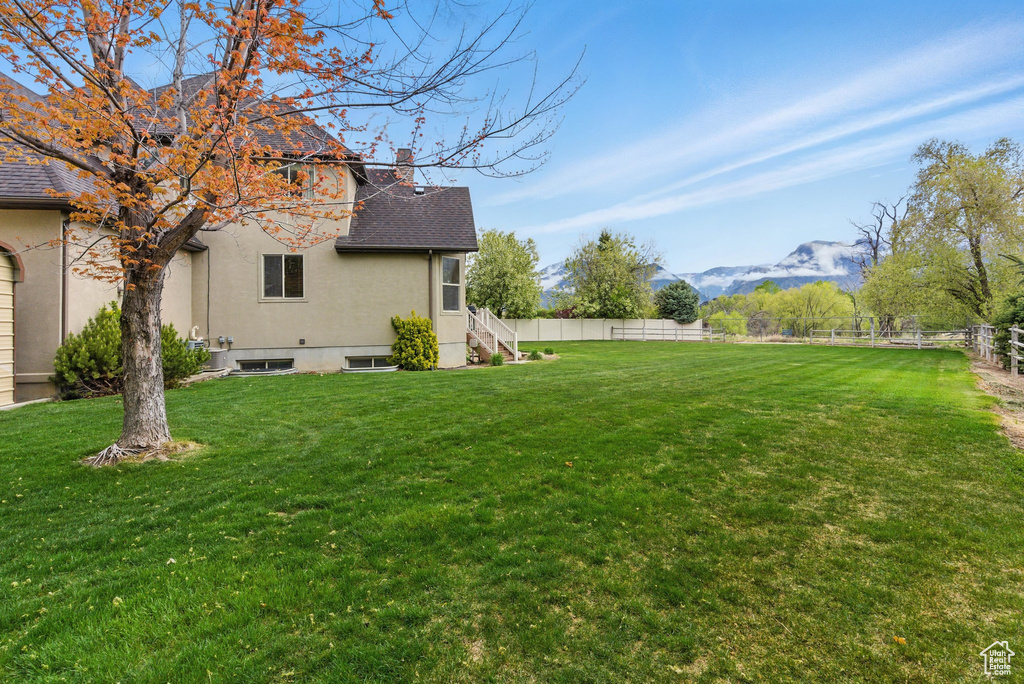 View of yard with fence and a mountain view