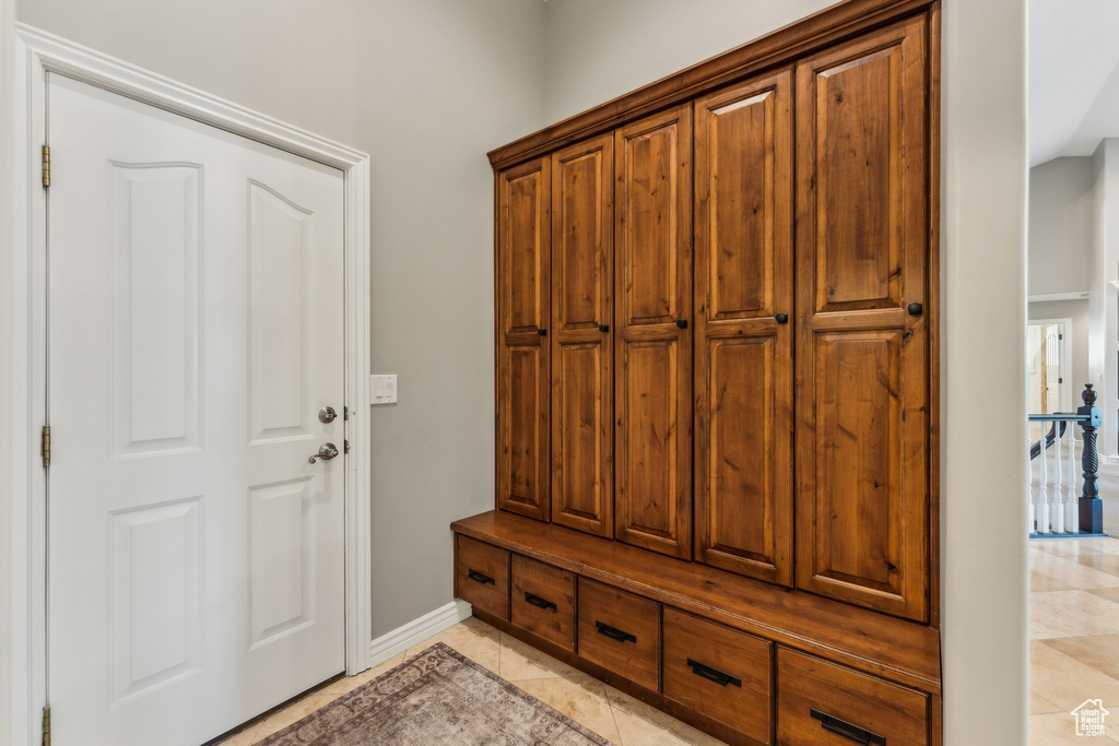 Mudroom featuring baseboards and light tile patterned flooring