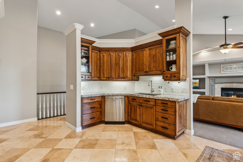 Kitchen with ceiling fan, vaulted ceiling, dishwasher, a sink, and open floor plan