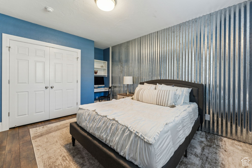Bedroom with wood-type flooring and a closet