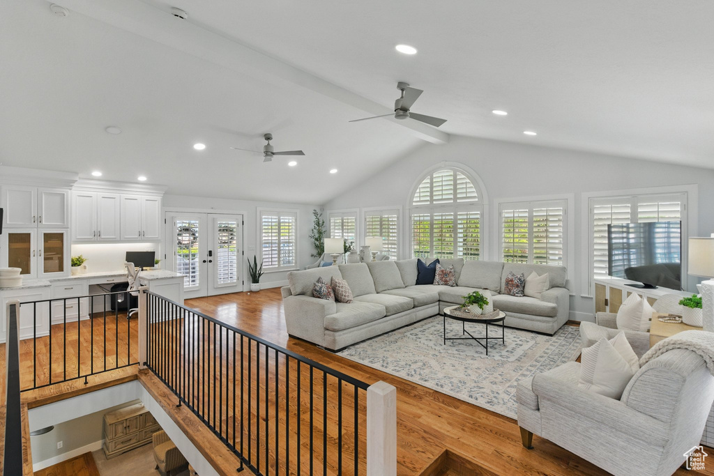 Living area with recessed lighting, french doors, vaulted ceiling, and wood finished floors