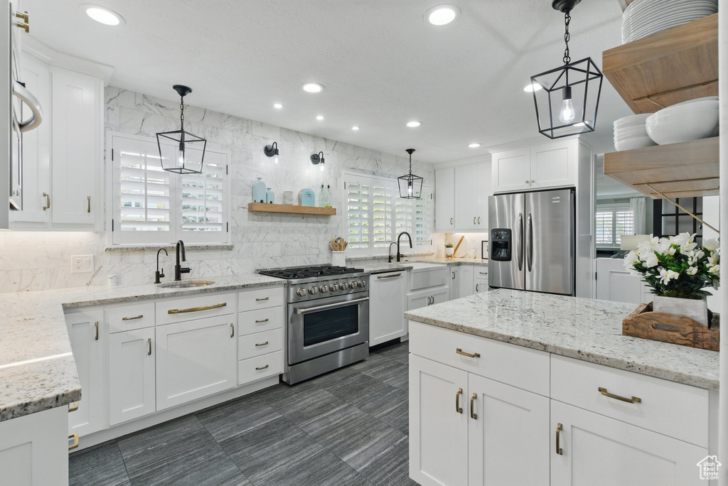 Kitchen with recessed lighting, a sink, white cabinetry, and stainless steel appliances