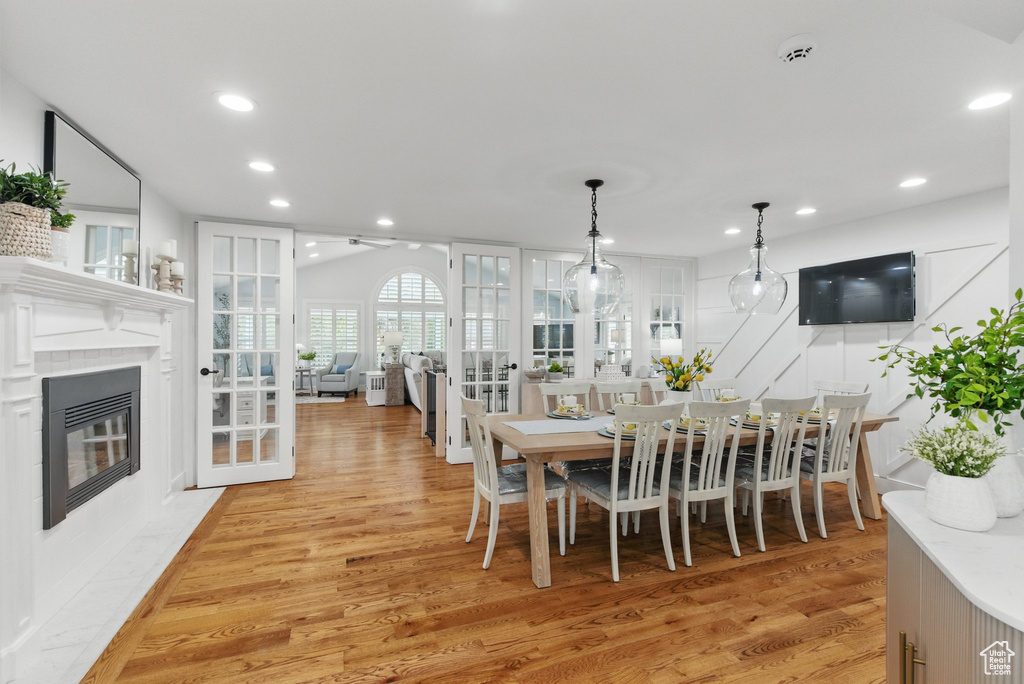 Dining room featuring recessed lighting, a high end fireplace, and light wood finished floors