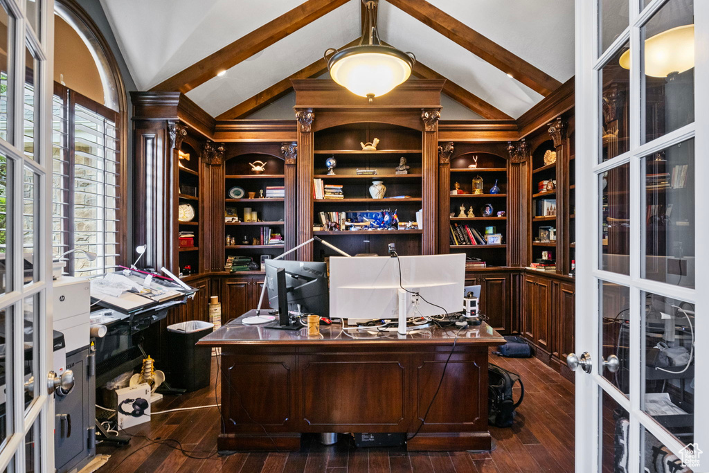 Office area with french doors, lofted ceiling with beams, dark wood-style flooring, and built in study area