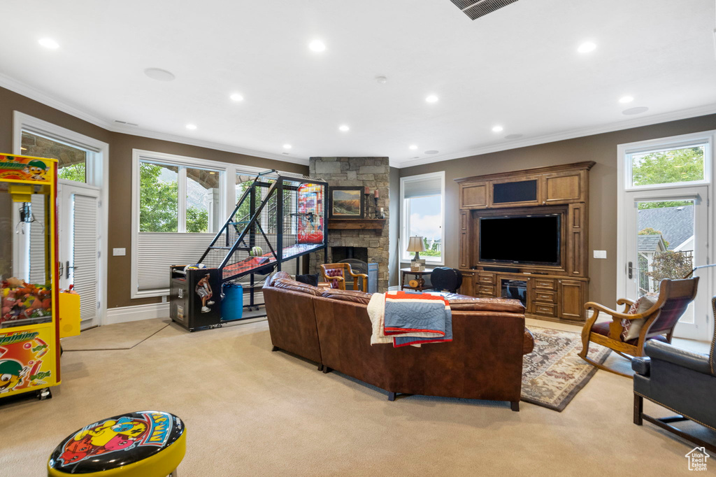 Living area featuring recessed lighting, light colored carpet, ornamental molding, and a fireplace