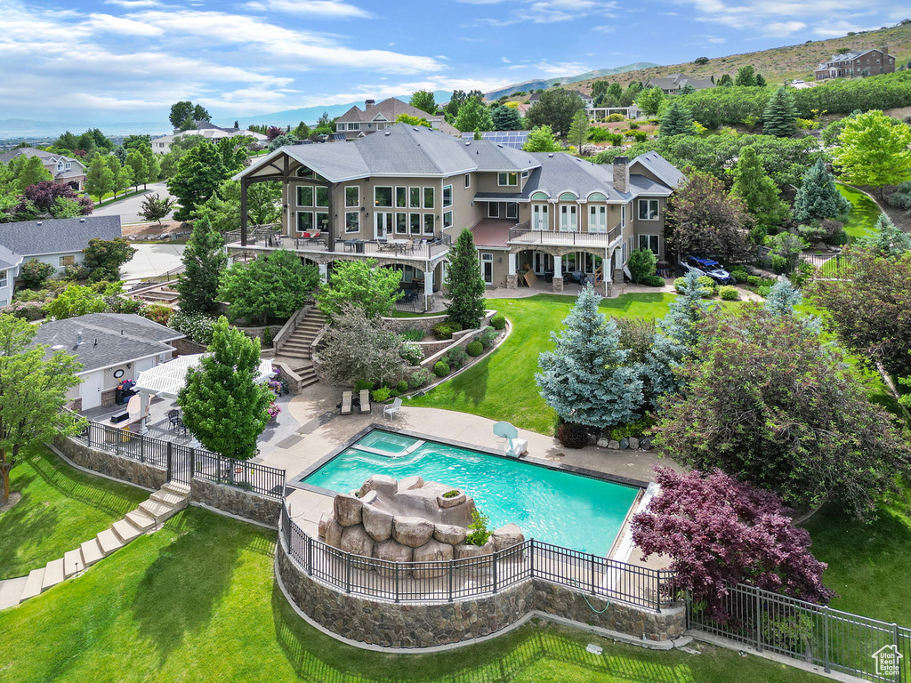 Rear view of house with a lawn, stairs, a fenced backyard, and a patio area