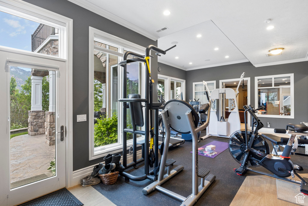 Exercise area featuring recessed lighting, ornamental molding, and visible vents