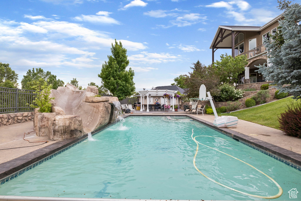 View of swimming pool with a fenced in pool, a patio area, and fence