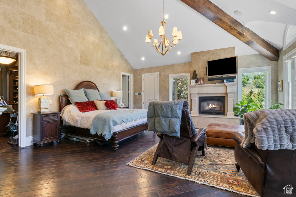Bedroom with an inviting chandelier, multiple windows, hardwood / wood-style floors, and high vaulted ceiling