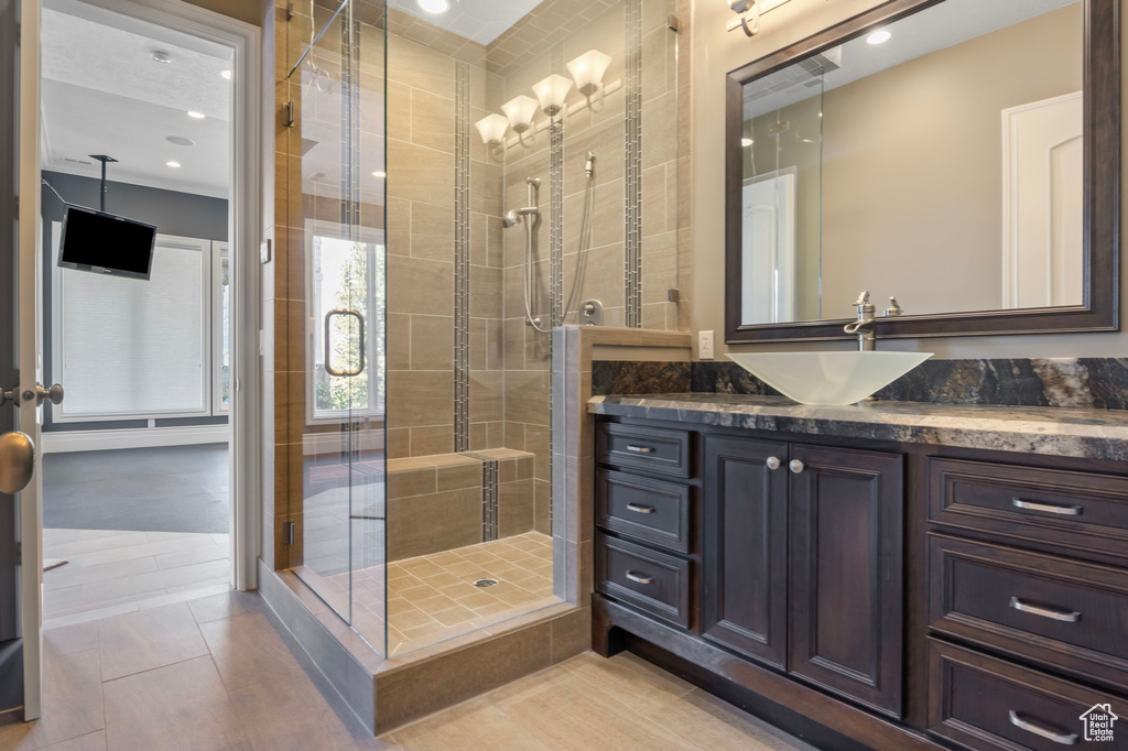 Bathroom with vanity, a stall shower, and recessed lighting