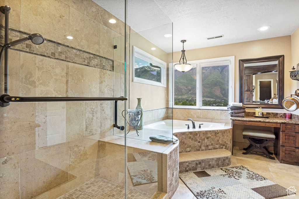 Bathroom with visible vents, tile patterned flooring, vanity, a bath, and a stall shower