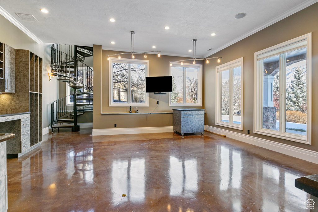 Unfurnished living room featuring crown molding, baseboards, stairs, and visible vents