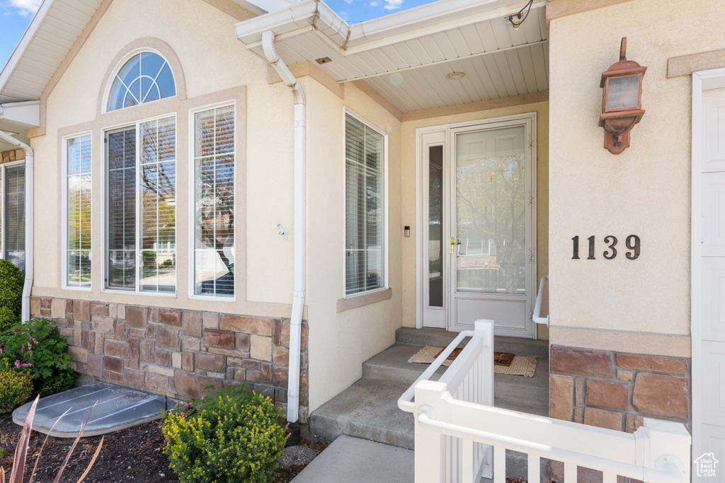 Property entrance with stucco siding and stone siding